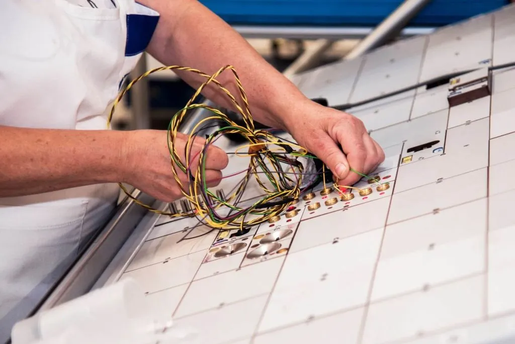 A wire harness undergoing testing at an assembly plant